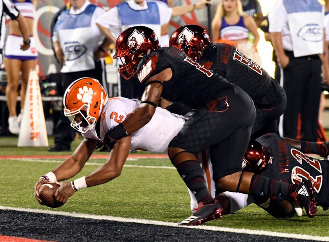 Clemson quarterback Kelly Bryant (2) is brought down by Louisville’s Dorian Etheridge, front right, and Trumaine Washington (15) as he crosses the goal line during the first half Saturday, Sept. 16, 2017, in Louisville, Ky. (AP Photo/Timothy D. Easley)