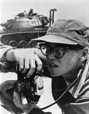 This 1958 photo provided by The United States Marine Corps shows. Photographer Dickey Chapelle is shown taking photos on the shores of Lake Michigan during a U.S. Marines operation. Chapelle, originally from Wisconsin who’s believed to be the first female U.S. journalist killed in a war has become an honorary Marine. Chapelle was declared an honorary Marine last month at the Marine Corps Combat Correspondents Association annual dinner. She died in 1965 at the age of 47 while covering the Vietnam war when a marine near her tripped a booby trap. (Lew Lowery/U.S. Marine Corps via AP)