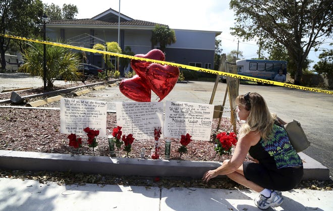 Janice Connelly of Hollywood, sets up a makeshift memorial in memory of the senior citizens who died in the heat at The Rehabilitation Center at Hollywood Hills. [Carline Jean / South Florida Sun-Sentinel via AP]