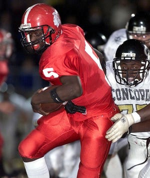 South Point's Devon Lowery runs past a Concord defender during November 11, 2000 playoff game at South Point High School. [FILE PHOTO/THE GASTON GAZETTE]
