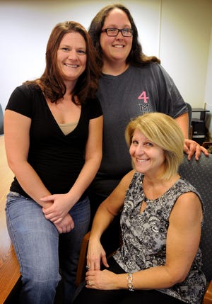 Kelsi Giebler (left), a former client of the Salina Housing Authority Family Self-Sufficiency Program, Rhonda Howell, a current client of the program, and KaySue Nothern, program coordinator. [TOM DORSEY / SALINA JOURNAL]