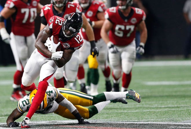 Atlanta Falcons wide receiver Taylor Gabriel (18) runs against Green Bay Packers cornerback Quinten Rollins (24) during the first of an NFL football game, Sunday, Sept. 17, 2017, in Atlanta. (AP Photo/John Bazemore)