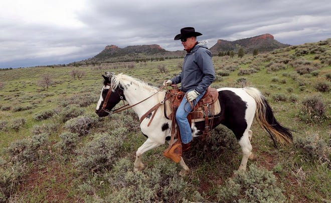 FILE - In this May 9, 2017, file photo, Interior Secretary Ryan Zinke rides a horse in the new Bears Ears National Monument near Blanding, Utah. Zinke is recommending that six of 27 national monuments under review by the Trump administration be reduced in size, along with management changes to several other sites. A leaked memo from Zinke to President Donald Trump recommends that two Utah monuments â€” Bears Ears and Grand Staircase Escalante â€” be reduced, along with Nevada's Gold Butte and Oregon's Cascade-Siskiyou (Scott G Winterton/The Deseret News via AP, File)
