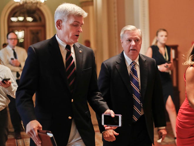 In this July 13, 2017, file photo, Sen. Bill Cassidy, R-La., left, and Sen. Lindsey Graham, R-S.C., right, talk while walking to a meeting on Capitol Hill in Washington. Senate Republicans are planning a final, uphill push to erase President Barack Obama’s health care law. But Democrats and their allies are going all-out to stop the drive. The initial Republican effort crashed in July in the GOP-run Senate. Majority Leader Mitch McConnell said after that defeat that he’d not revisit the issue without the votes to succeed. Graham and Cassidy are leading the new GOP charge and they’d transform much of Obama’s law into block grants and let states decide how to spend the money. (AP Photo/Pablo Martinez Monsivais, File)