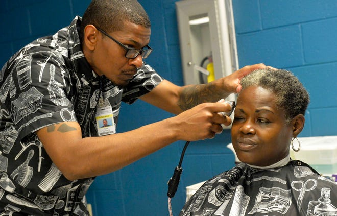 Leon Givens, a barbering student at Savannah Technical College, cuts Miriam Washington-Fraser’s hair at the annual Stand Down for Homelessness event held at the Civic Center. (Steve Bisson/Savannah Morning News)