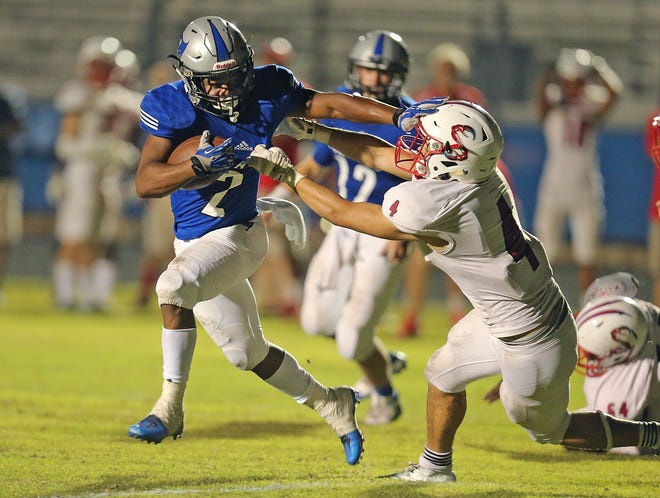Matanzas running back Trent Steward (2) is tackled near the goal line by Seabreeze's Zach McNeely (4) to set-up a score for Matanzas on the next play Monday night in Palm Coast in a game won by Matanzas, 40-0. [News-Tribune/Nigel Cook]