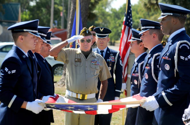 Al Reynolds, past commander and member of the Honor Guard of VFW Post 1432, salutes Wednesday morning during a grave side service for Earl Schaeffer in Assaria. The VFW Post 1432 Honor Guard and the McConnell Air Force Base Honor Guard performed military rites for the funeral. [TOM DORSEY / SALINA JOURNAL]