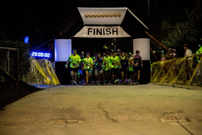 Runners take off from the starting line for the 5k "Glow Fest" fun run and walk on Sept. 9 in Festival Park. [Johnathan Williams for The Fayetteville Observer]