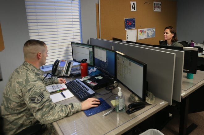 Staff Sgt. Christopher Floyd works across from Maj. Cherie Clark on Wednesday at the AFNORTH Rescue Coordination Center at Tyndall Air Force Base. [PATTI BLAKE/THE NEWS HERALD]