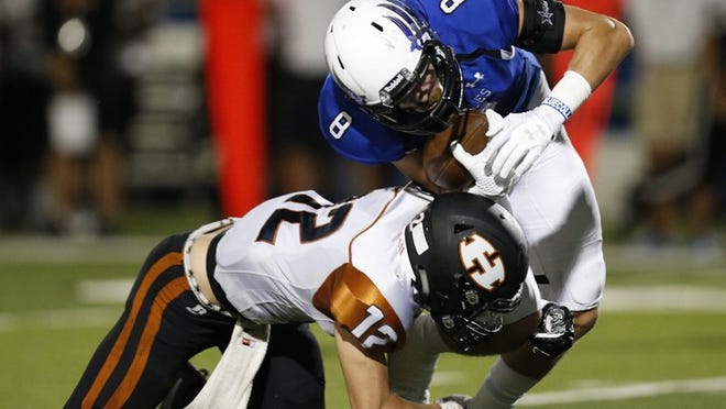 Hutto’s Jared Herrick, left, tackles Georgetown’s Nic Crombie during the District 19-5A opener for the two teams last week. Hutto won the matchup 25-23 when Isodoro Barrios kicked a 32-yard field goal on the game’s final play. With nine schools grouped in 19-5A, the district’s football teams have the benefit of only two non-district games. CREDIT: Stephen Spillman/For American-Statesman