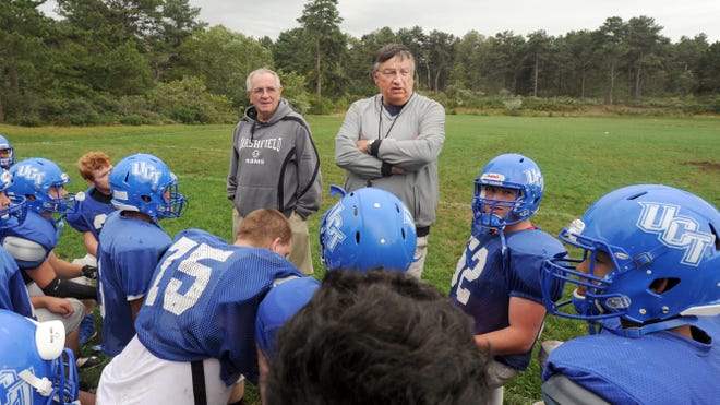 Ken Owen, the new head football coach at Upper Cape Tech, and assistant coach Tom Bailey talk with their team during practice Thursday. The Rams face rival Cape Tech on Saturday. [Ron Schloerb/Cape Cod Times]