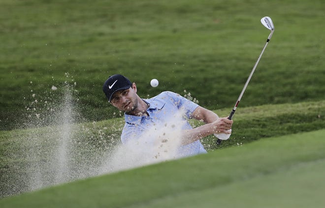 Kyle Stanley hits out of the bunker on the 18th hole during the first round of the Tour Championship golf tournament at East Lake Golf Club in Atlanta, Thursday, Sept. 21, 2017. (AP Photo/David Goldman)