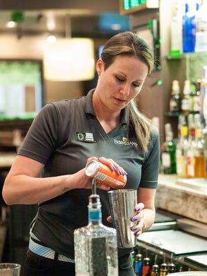 Kodie Daniels shares her mixology knowledge with the lucky patrons of Bennigan's in the Panama City Mall.