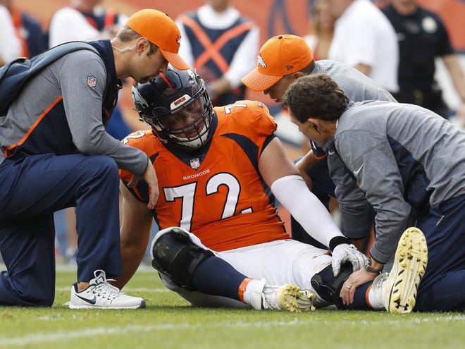 Denver Broncos offensive tackle Garett Bolles (72) is helped after an injury against the Dallas Cowboys during the second half of an NFL football game, Sunday, Sept. 17, 2017, in Denver. Broncos coach Vance Joseph says rookie tackle Garett Bolles' left leg injury isn't as serious as first feared. Joseph says Bolles has a bone bruise in his lower left leg and is week to week. The Broncos' first-round draft pick was injured in Denver's win over Dallas.(AP Photo/Joe Mahoney)