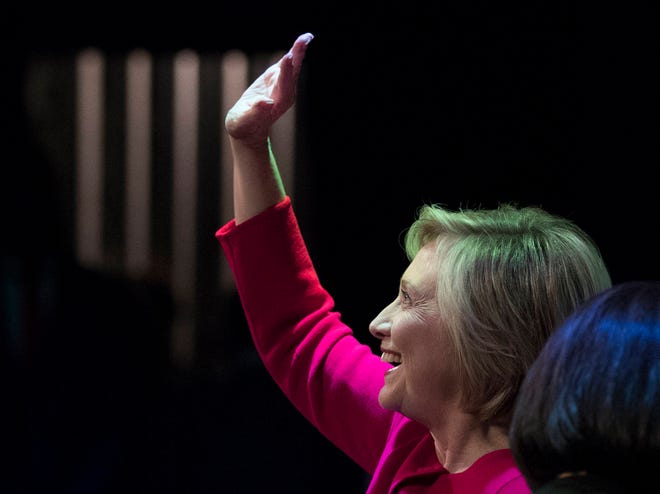 Hillary Clinton waves to the audience at the Warner Theatre in Washington, Monday, Sept. 18, 2017, for book tour event for her new book “What Happened” hosted by the Politics and Prose Bookstore. (AP Photo/Carolyn Kaster)