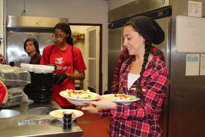 Bay High School band students prepare, serve and clean up a Greek spaghetti dinner during their 2016 fundraiser event to support often pricey band activities. [CONTRIBUTED PHOTO]