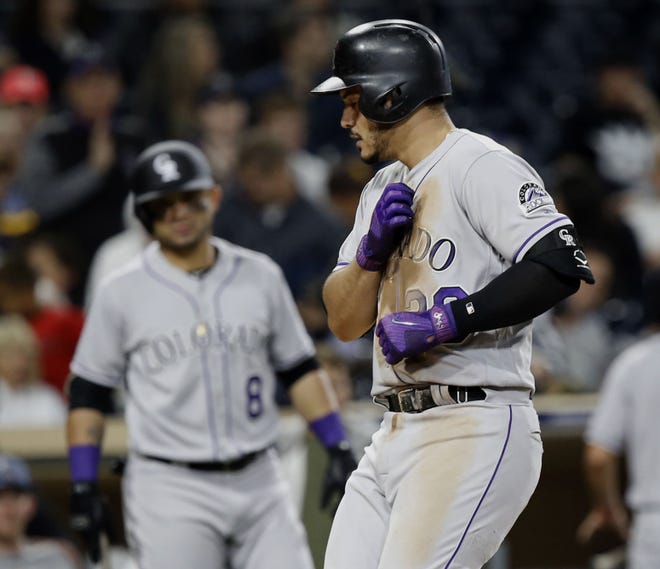 Colorado Rockies' Nolan Arenado reacts at the plate after hitting a solo home run against the San Diego Padres during the fifth inning of a baseball game in San Diego, Friday, Sept. 22, 2017. (AP Photo/Alex Gallardo)