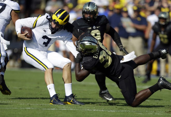 Michigan quarterback Wilton Speight (3) is sacked by Purdue linebacker Danny Ezechukwu (36) during the first half Saturday in West Lafayette, Ind. (AP Photo/Michael Conroy)