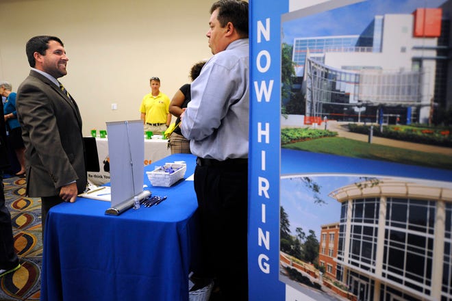 Patrick McCauley, left, talks to Augusta University talent consultant Jacob Usry during a job fair hosted by Goodwill Industries of Middle Georgia and the CSRA in this 2015 file photo. FILE/STAFF