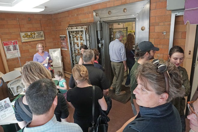 Visitors tour a vault Saturday at Hudson Fur Co., 101 Cranston St., Providence, the scene of the brazen Bonded Vault heist of about $32 million in cash, jewels and gold bars in 1975. [The Providence Journal / Sandor Bodo]