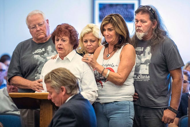 Hattie Stretz, second from left, a survivor of the Salon Meritage hair salon shooting in 2011, is comforted by Bethany Webb, the sister of Laura Webb Elody, one of eight people killed, and family as she speaks to Scott Dekraai during a victim impact statement in Superior Court in Santa Ana, Calif., Friday, Sept. 22, 2017. Dekraai, a 47-year-old former tugboat operator, received eight consecutive life terms for the murders of his hairstylist ex-wife, her co-workers and others in the tight-knit seaside community of Seal Beach. (Mark Rightmire/The Orange County Register via AP)