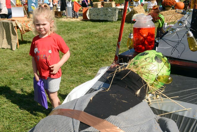 Rosalynn Haag, 4, of Gales Ferry, keeps her distance from a Frankenstein scarecrow Saturday at the 12th annual Scarecrow Festival in Preston. See videos and more photos at NorwichBulletin.com [Photos by John Shishmanian/ NorwichBulletin.com]