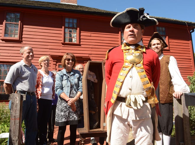 Kevin Titus, of Canaan, portraying Benedict Arnold, talks about the pretend leg Dayne Rugh, of Norwich, right, presented to Norwich Mayor Deb Hinchey Saturday during the Benedict Arnold Returns event at the Leffingwell House Museum in Norwich. At left is former Norwich Mayor Peter Nystrom and State Sen. Cathy Osten. See videos and more photos at NorwichBulletin.com [John Shishmanian/ NorwichBulletin.com]