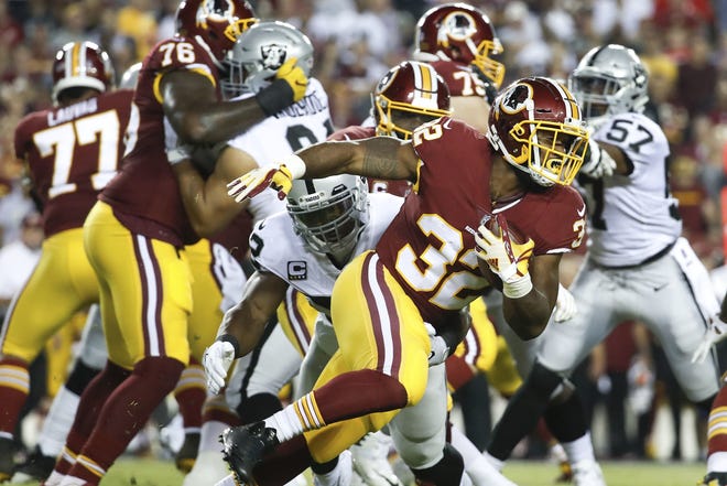 Washington Redskins running back Samaje Perine carries the ball during the first half against the Oakland Raiders on Sunday in Landover, Md. [AP Photo/Alex Brandon]