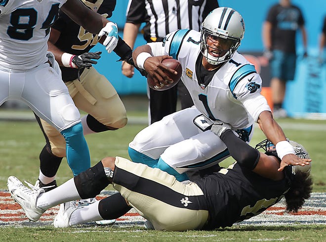 Cam Newton is sacked by Hau'oli Kikaha during the Panthers 34-13 loss to the New Orleans Saints Sunday at Bank of America Stadium. [JOHN CLARK/THE GASTON GAZETTE]