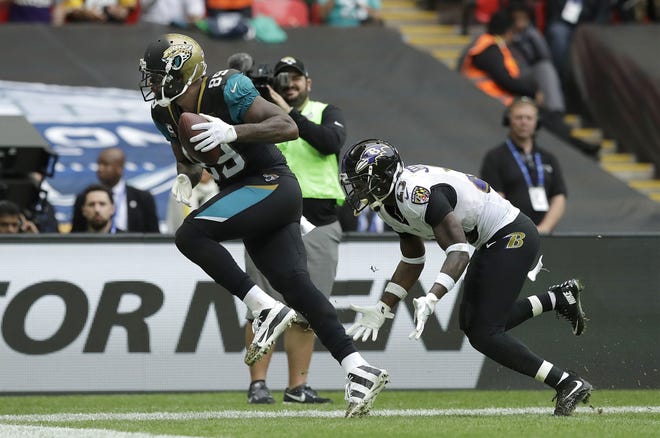 Jacksonville tight end Marcedes Lewis scores a touchdown past Baltimore strong safety Tony Jefferson during the second half on Sunday at Wembley Stadium in London. [MATT DUNHAM/THE ASSOCIATED PRESS]