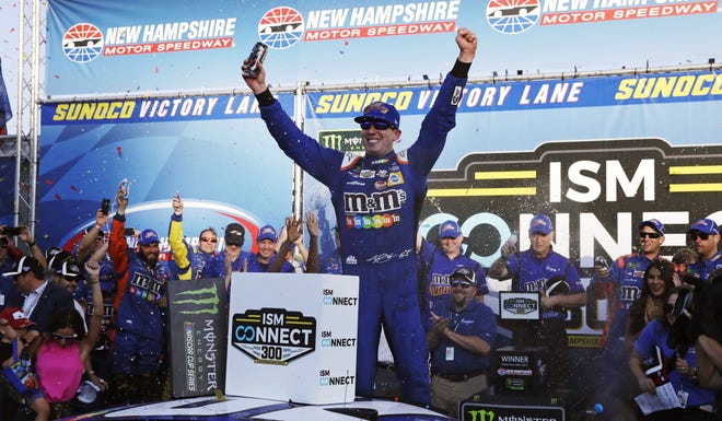 Kyle Busch raises his arms after winning the NASCAR Cup Series auto race at New Hampshire Motor Speedway in Loudon, N.H. [CHARLES KRUPA/THE ASSOCIATED PRESS]