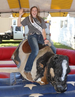 2017 Tuscarawas County Fair Queen Lauren Rennicker rides the mechanical bull at the fair Saturday. (Timesreporter.com / Jim Cummings)