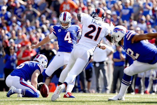Buffalo Bills kicker Stephen Hauschka (4), with Colton Schmidt holding, kicks a field goal against the Denver Broncos during the second half of an NFL football game, Sunday, Sept. 24, 2017, in Orchard Park, N.Y. (AP Photo/Adrian Kraus)