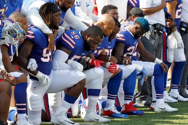Buffalo Bills players kneel during the national anthem prior to an NFL football game against the Denver Broncos, Sunday, Sept. 24, 2017, in Orchard Park, N.Y. (AP Photo/Jeffrey T. Barnes)