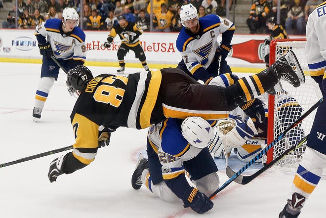 Pittsburgh Penguins' Sidney Crosby (87) is upended by St. Louis Blues' Paul Stastny as he tries to get to the puck in the go rease during the third period of the NHL preseason game Sunday in Cranberry, Pa.