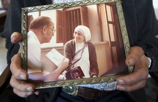 Hayden Rice of Ellwood City holds a framed photograph of himself and Mother Theresa taken in Calcutta, India.
