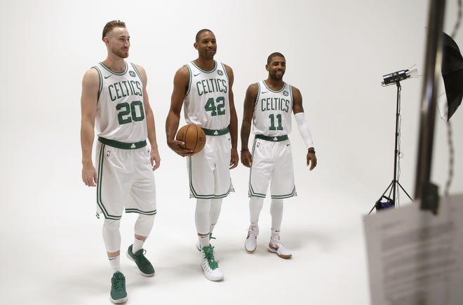 The Celtics' new Big Three of Gordon Hayward, left, Al Horford, center, and Kyrie Irving during a photo shoot at the team's media day on Monday. [Steven Senne/AP]