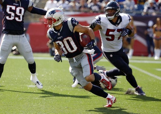 Patriots wide receiver Danny Amendola (80) runs from Houston linebacker Brennan Scarlett (57) after catching a pass during the first half of 36-33 victory over the Texans on Sunday in Foxboro. [AP Photo/Michael Dwyer]