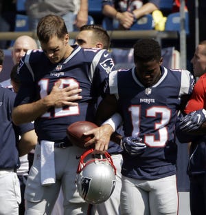 Prior to the Patriots' win over the Texans on Sunday, quarterback Tom Brady (left) locked his left arm with Phillip Dorsett's right and held his right hand over his heart during the playing of the national anthem. On Monday, Brady called comments by President Donald Trump that sparked unprecedented protests throughout the NFL on Sunday "divisive."