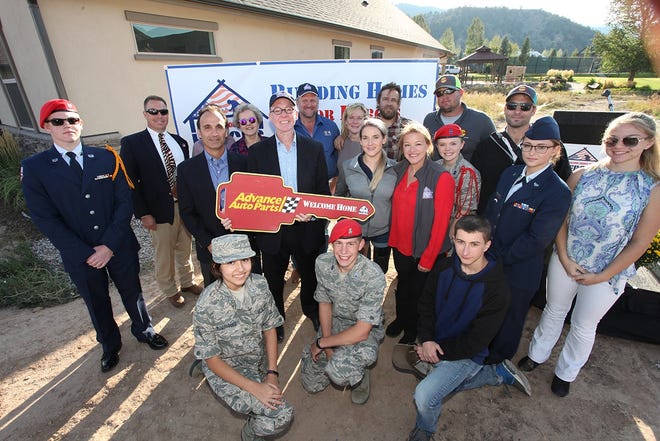 Sgt. Kirstie Ennis, center, receives a home from Building Homes for Heroes in Glenwood Springs, Colo. [Gary DeJidas | Special to the Press Gazette]