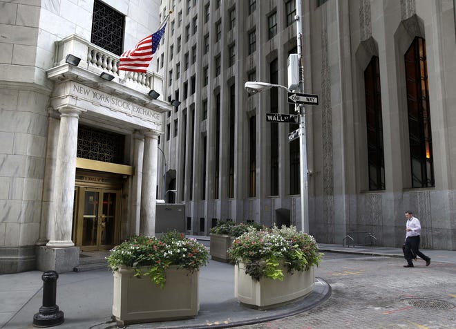 In this Aug. 24, 2015, file photo, a man walks towards the New York Stock Exchange. Technology stocks slammed into reverse on Monday, and the losses overshadowed gains in other areas of the market to send broad U.S. indexes lower. [AP Photo/Seth Wenig]