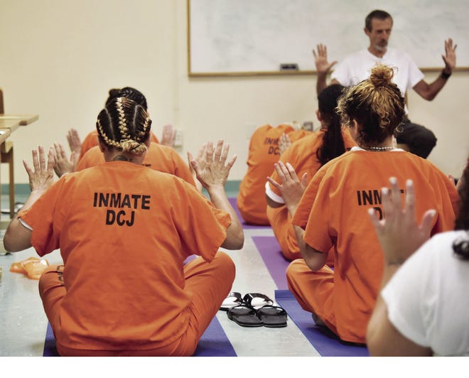 Lawrence Huff leads a weekly yoga class at the Metro West Detention Center near Doral, Fla. (Photo Courtesy Miami-Dade Corrections & Rehabilitation Department)