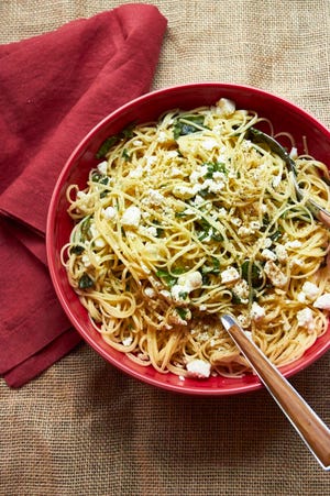 This December 2016 photo shows linguine with lemon, feta and basil in New York. This dish is from a recipe by Katie Workman. (Mia via AP)