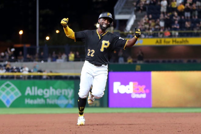 Pittsburgh Pirates' Andrew McCutchen celebrates as he heads to third base after hitting his first career grand slam against the Baltimore Orioles Tuesday in Pittsburgh.