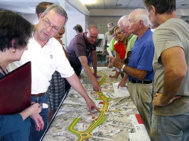 Members of the public view the NCDOT's proposed plan to widen a one-mile section of U.S. 64 during an open house Tuesday at First Congregational Church Laurel Park. [ANDREW MUNDHENK/TIMES-NEWS]