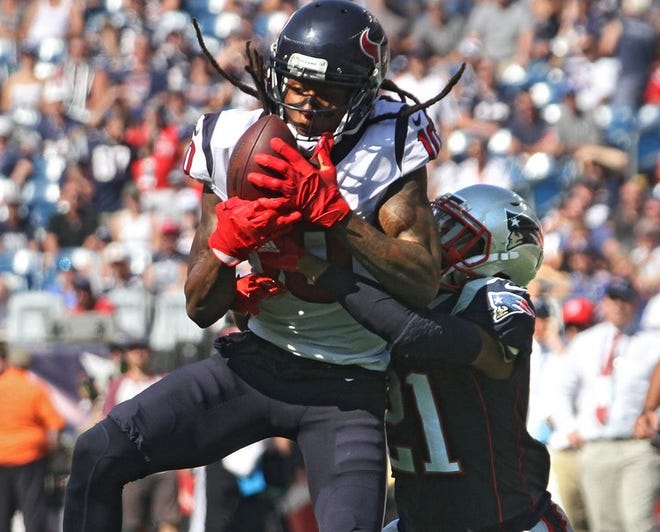 Houston's DeAndre Hopkins catches a pass for short yardage as Patriots cornerback Malcolm Butler defends.