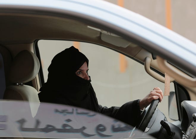 In this March 29, 2014 file photo, Aziza Yousef drives a car on a highway in Riyadh, Saudi Arabia, as part of a campaign to defy Saudi Arabia's ban on women driving. Saudi Arabia says it will allow women to drive for the first time in the ultra-conservative kingdom. [HASAN JAMALI/AP PHOTO]