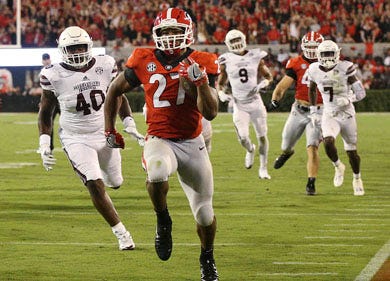 Georgia tailback Nick Chubb runs away from Mississippi State defenders for a touchdown during the second half of an NCAA college football game Saturday, Sept. 23, 2017, in Athens, Ga. (Curtis Compton/Atlanta Journal Constitution via AP)