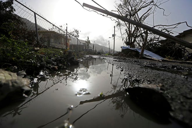 Downed power lines and debris are seen in the aftermath of Hurricane Maria in Yabucoa, Puerto Rico, Tuesday, Governor Ricardo Rossello and Resident Commissioner Jennifer Gonzalez, the island’s representative in Congress, have said they intend to seek more than a billion in federal assistance and they have praised the response to the disaster by President Donald Trump, who plans to visit Puerto Rico next week, as well as FEMA Administrator Brock Long.