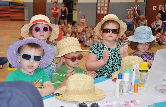 Maura Flynn, a SunAWARE educator and advocacy coordinator, is pictured on right giving her presentation on sun protection and skin cancer awareness at Harry M. Fisher Elementary School on Wednesday. Pictured are some students who got to put on wide brimmed hats and sunglasses following the presentation. [CUYLE ROCKWELL/CENTRAL VALLEY CENTRAL SCHOOL DISTRICT]